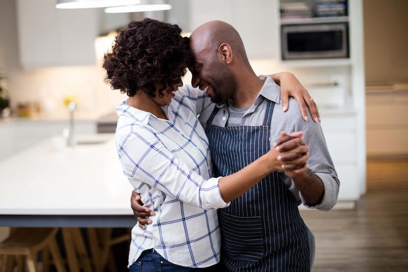 Couple dancing together in the kitchen